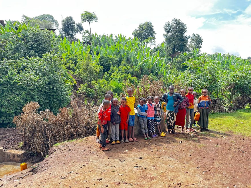 clean water project in Ethiopia by Hawassa Hope. A group of kids are standing next to it.